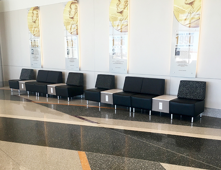 Airport seating with power outlets, stone top tables