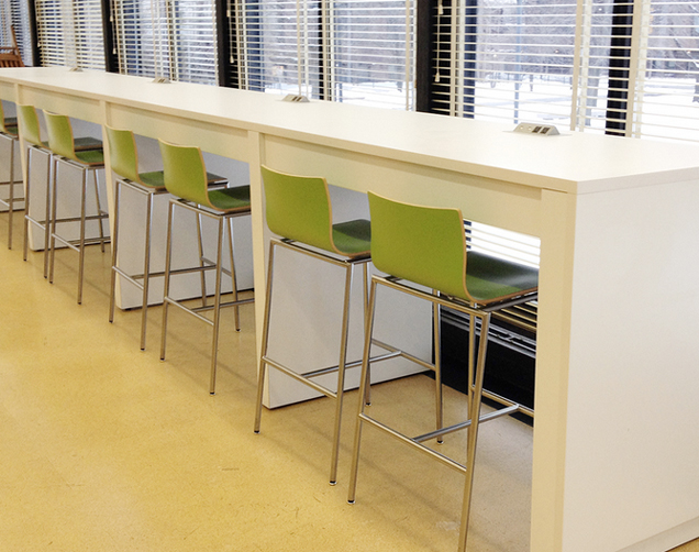 custom cafe height charging table with solid surface top in University Library