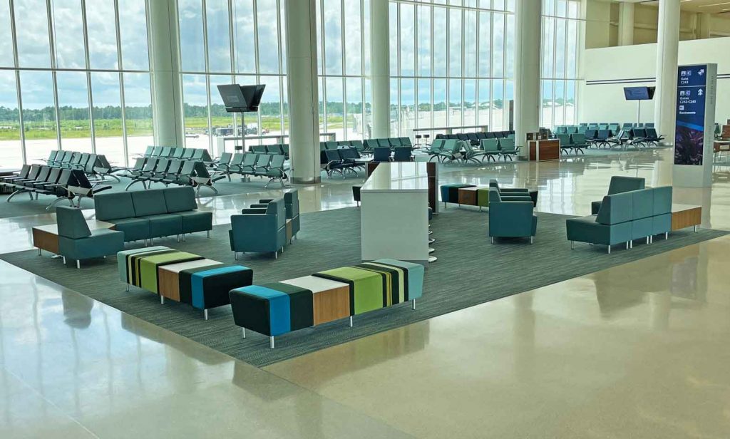 Airport seating with lounge chairs, benches and powered occasional table and charging table